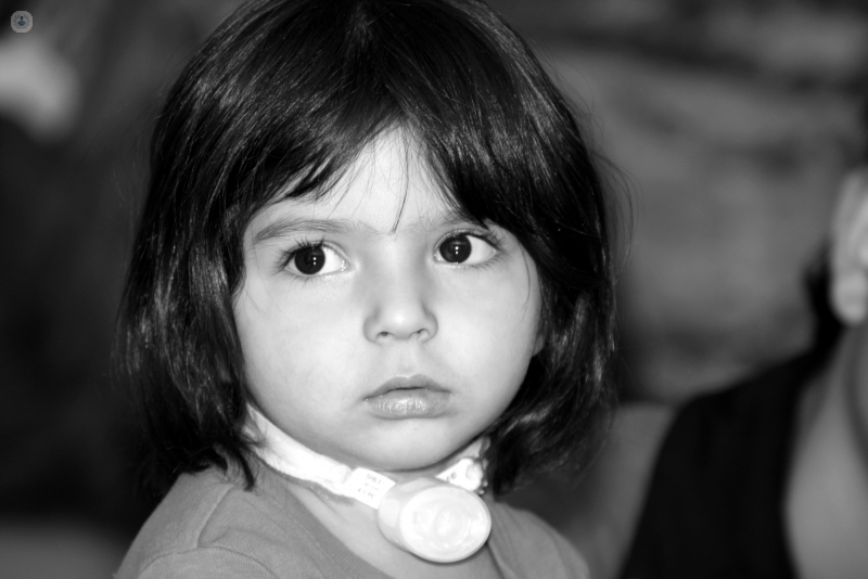 Little girl wearing a tracheostomy tube 