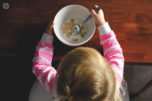 Tooth decay in children can affect those like this little girl, who is eating cereal and milk