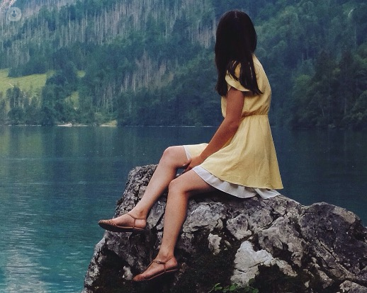 girl sitting on a rock after microsclerotherapy