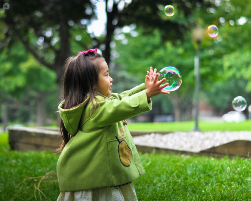 girl with bubble in hands