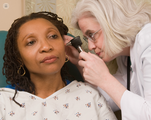 Women with tinnitus having her ear examined