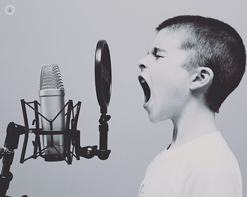 Boy shouting into a microphone