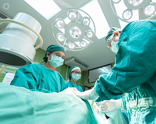 Three surgeons during a procedure