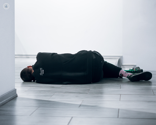 Narcoleptic asleep on a gallery floor