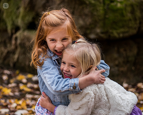 Two girls hugging and laughing