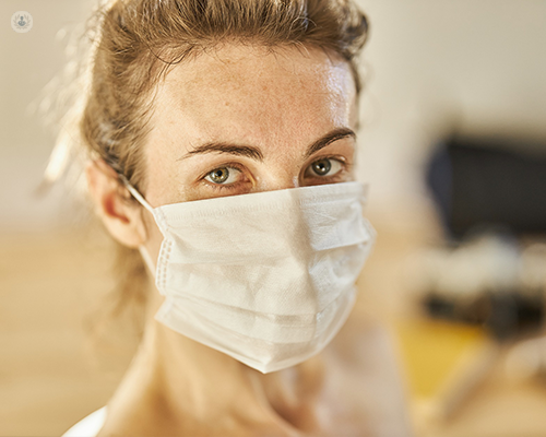A woman wearing a surgical mask