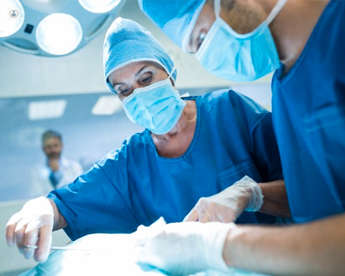 Surgeons operating on a patient. 