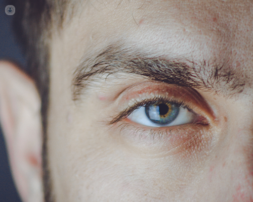 A man's face with a close up on his right eye eye 