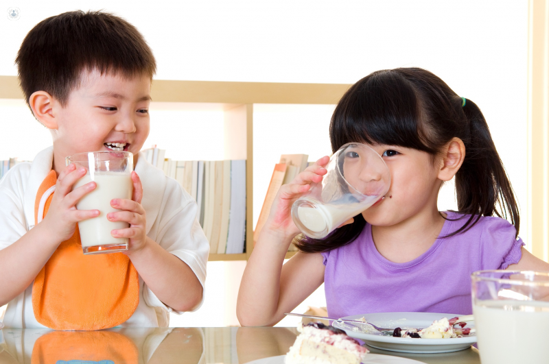 Children drinking milk, which is important to boost vitamin D deficiency