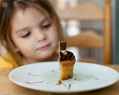 Child looking at a slice of cake