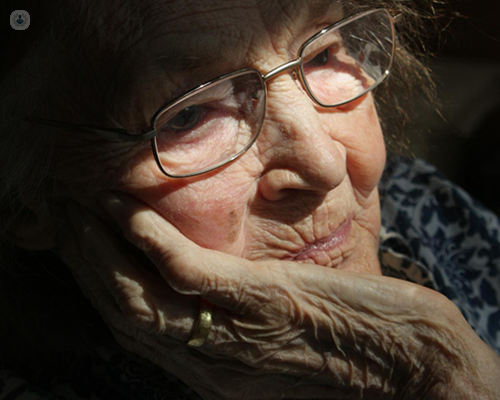 Older woman holding her chin