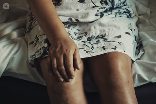 Woman rubbing her knee